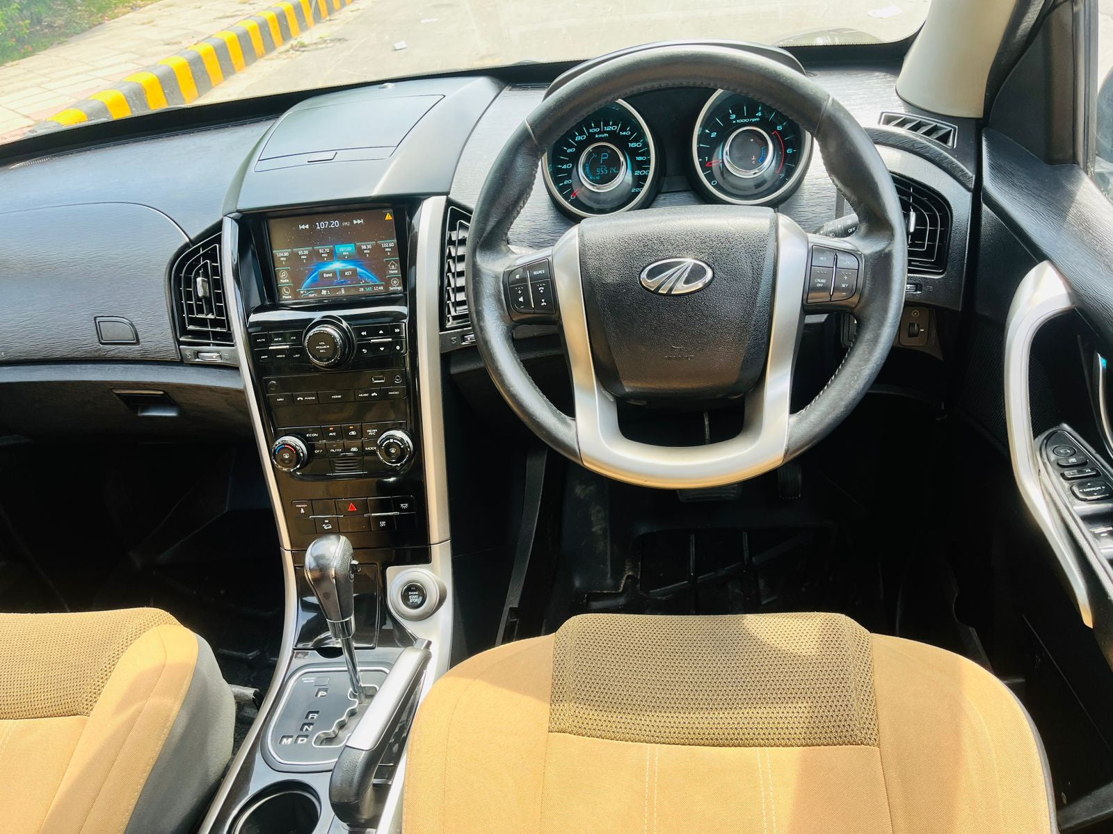 Car interior with steering wheel and dashboard view