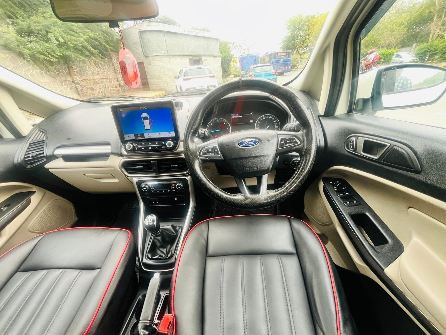 Car interior with dashboard, steering wheel, and seats.