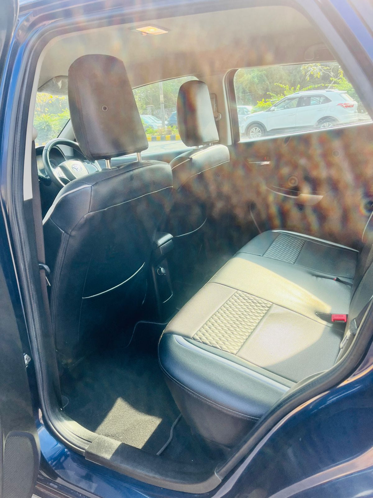 Car interior with a focus on the back seat and dashboard.