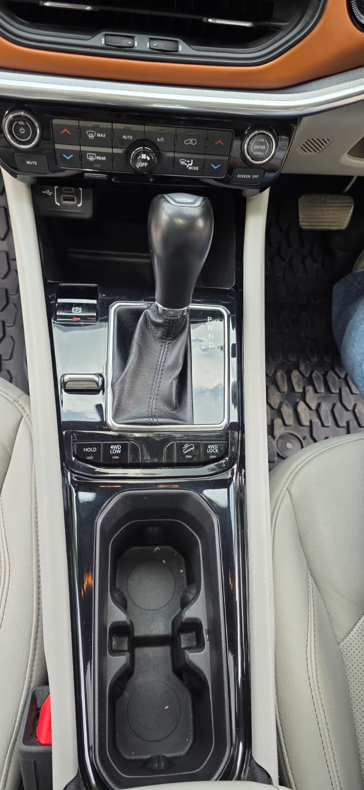 Car interior with gear shift and cup holder