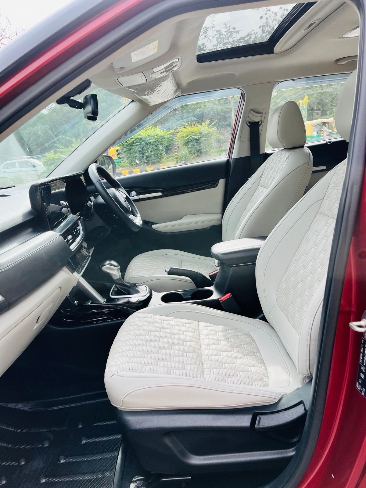 Car interior with white quilted seat covers and red exterior