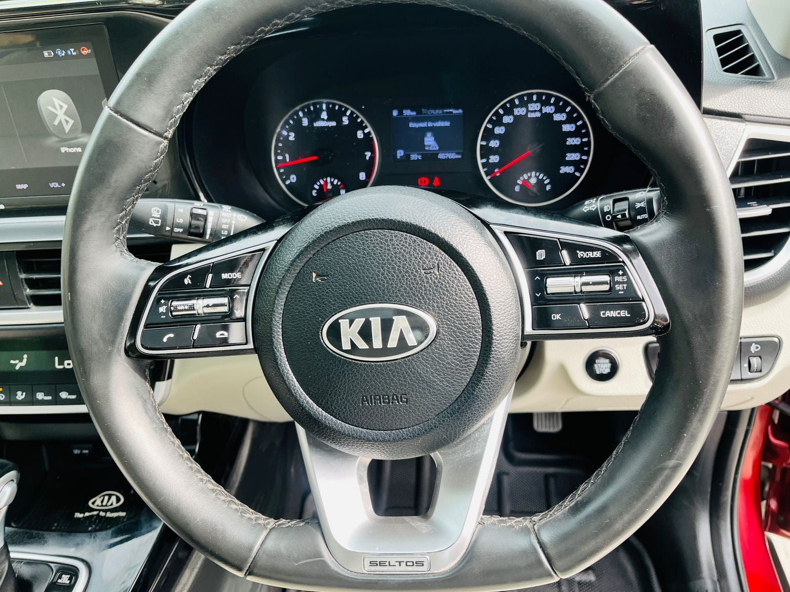 Steering wheel with Kia logo in a car interior