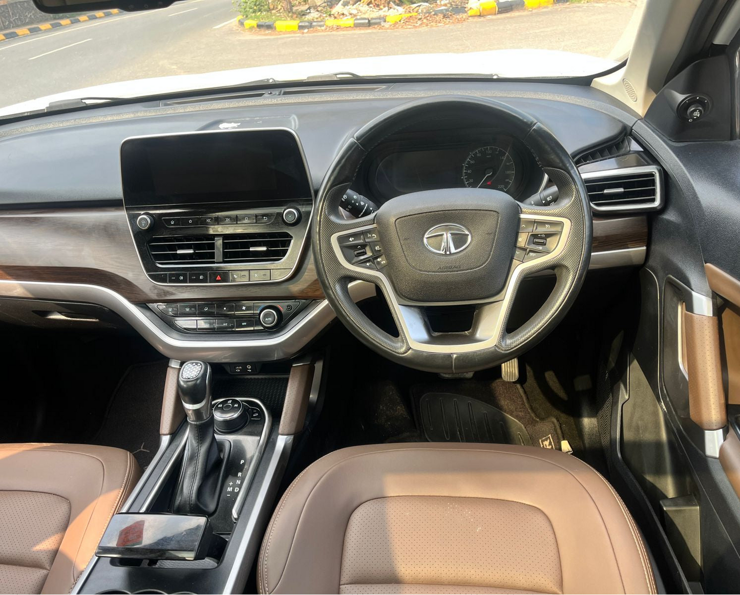 Car interior with steering wheel and dashboard view