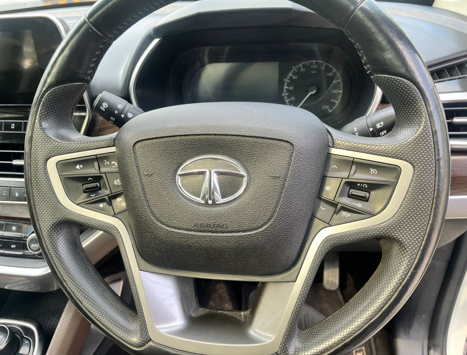 Steering wheel with Tata logo in a car interior