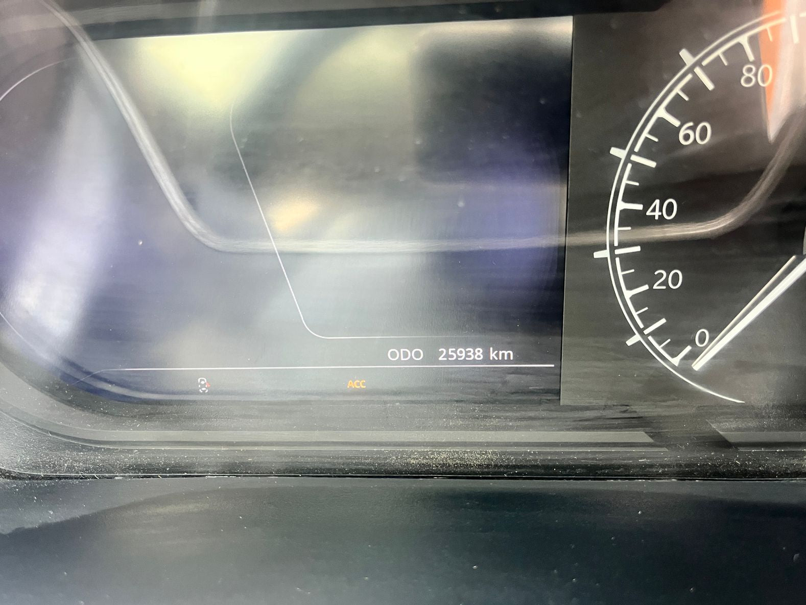 Car dashboard with digital display and speedometer