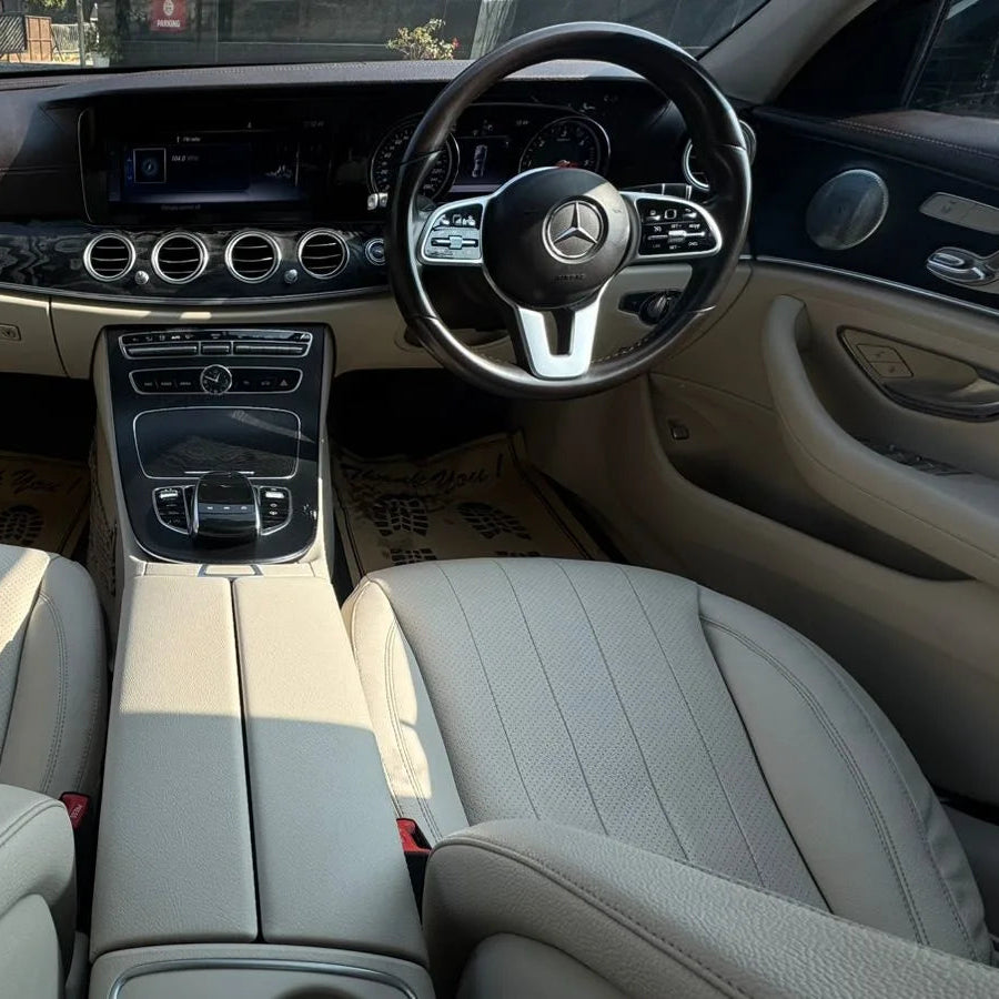 Car interior with steering wheel and dashboard of a Mercedes-Benz.