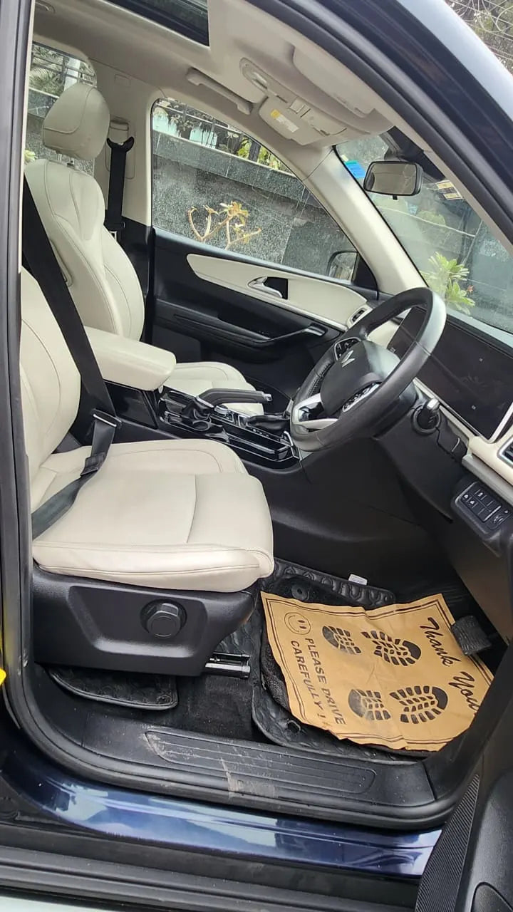 Car interior with a cardboard box on the floor