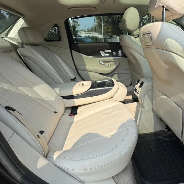 Car interior with beige seats and visible door panel.