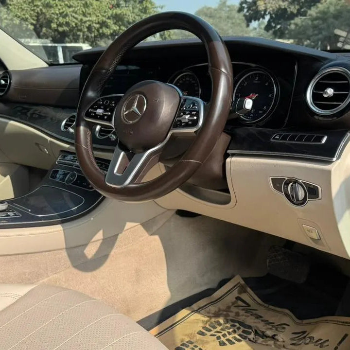Car interior with steering wheel and dashboard of a Mercedes-Benz.