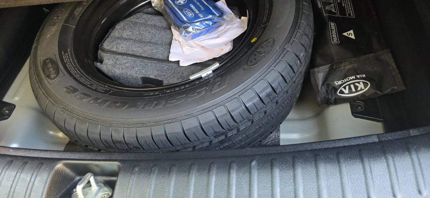 Tire in a car trunk with visible branding