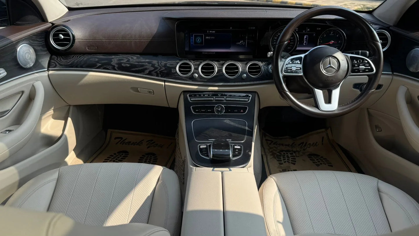 Car interior with steering wheel and dashboard of a Mercedes-Benz.