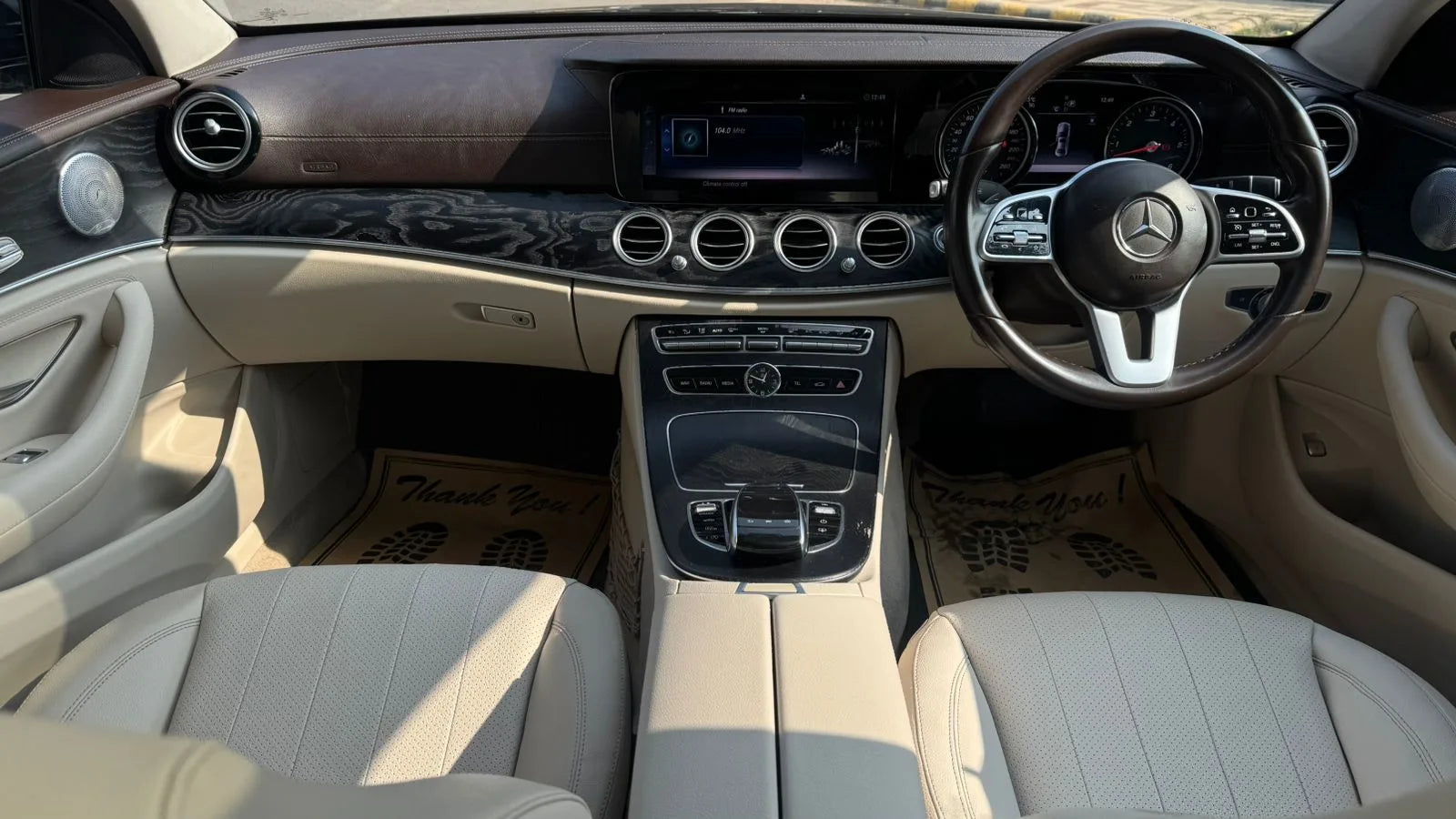 Car interior with steering wheel and dashboard of a Mercedes-Benz.