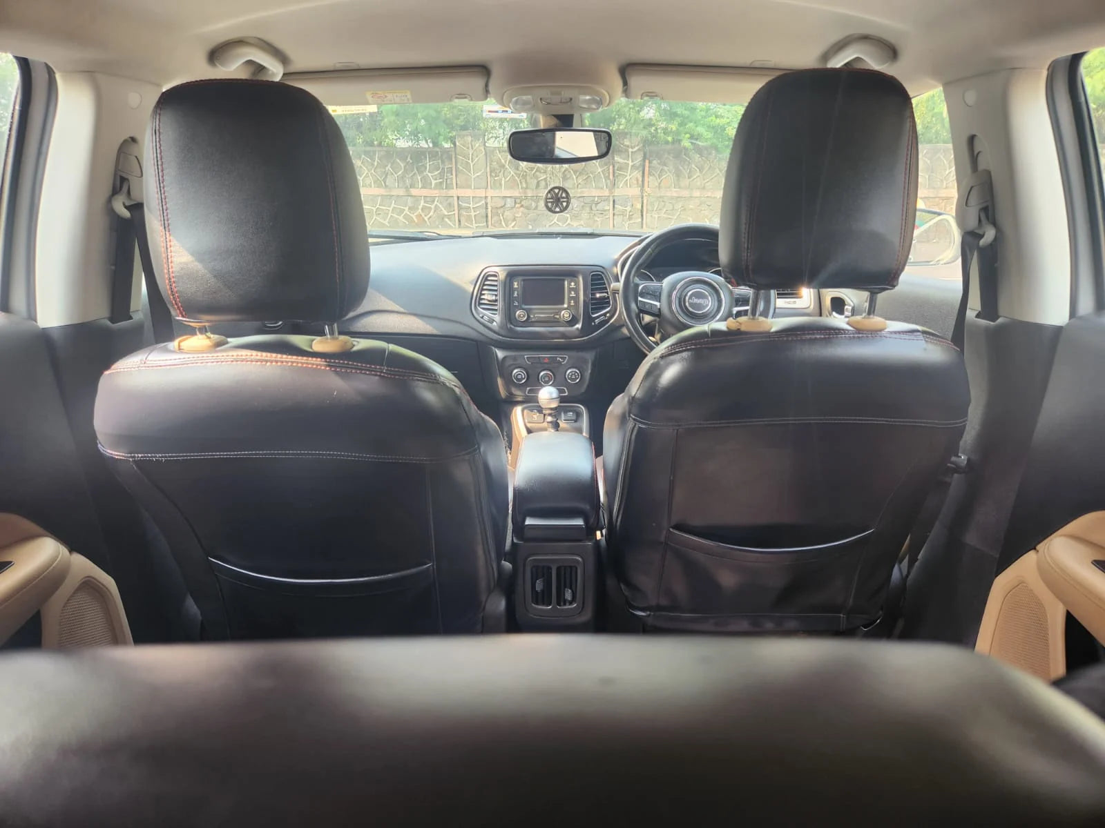 Car interior with black leather seats and visible dashboard.