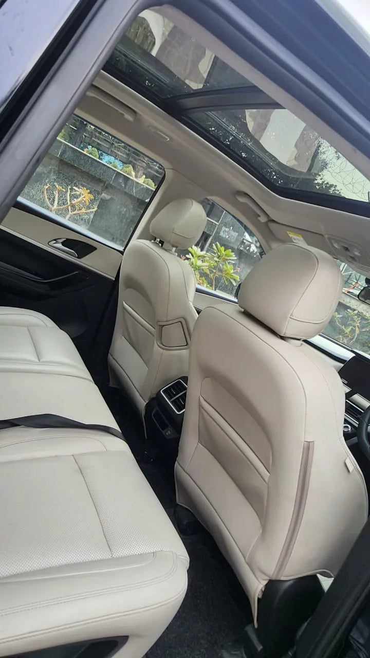 Beige car interior with visible seats and windows.